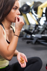 Happy woman having a break from exercising in health club