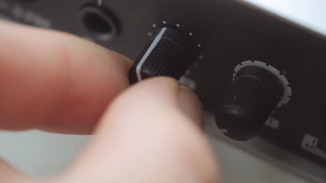 Hand adjusting the volume on an sound card