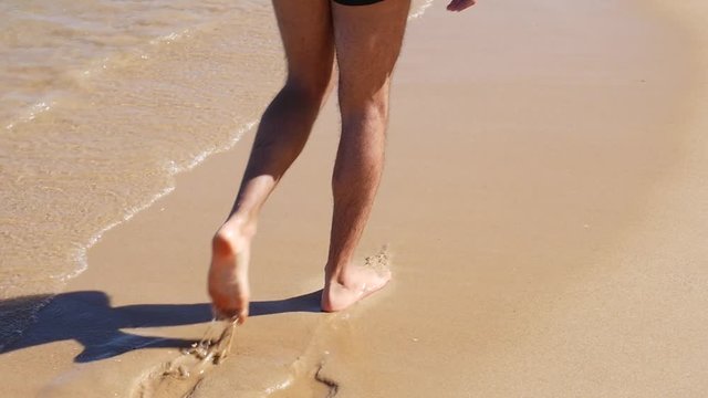 Guy walking on beach
