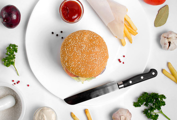 Burger topped with vegetables, spices and fries