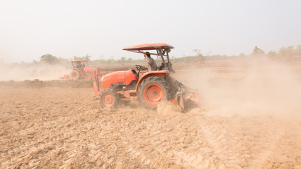 Tractor plows a field shoveling