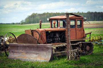Old rusty crawler tractor with shovel