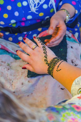 Woman applying henna tattoo