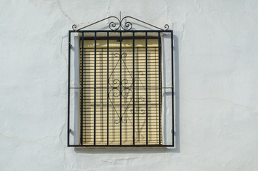 Obraz premium Shuttered window with black metal railings