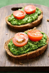 Sandwiches with pesto sauce and tomatoes