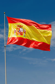 Spain flag waving on the sky