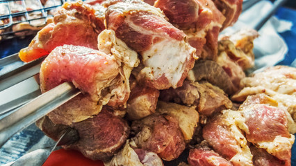 Raw meat skewers cooking