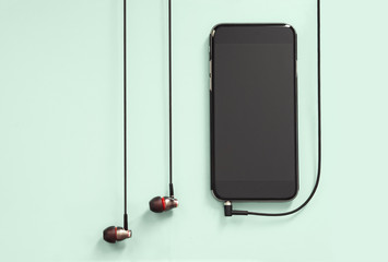 Headphones and Device on Colored Background
