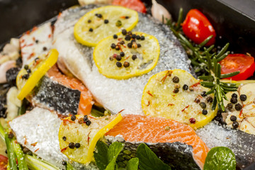 Fresh sea bream and salmon on dark  background