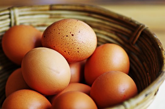 Egg. Eggs in wooden basket. Fresh organic eggs in wooden basket. Eggs background. Food background.