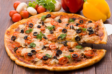 Pizza with ham, pepper and olives