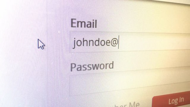 Person entering their email address and password to login to site.
