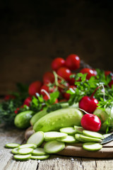 Round zucchini slices and fresh radish, vintage wooden backgroun