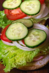 Sandwich with lettuce leaves and fresh vegetables