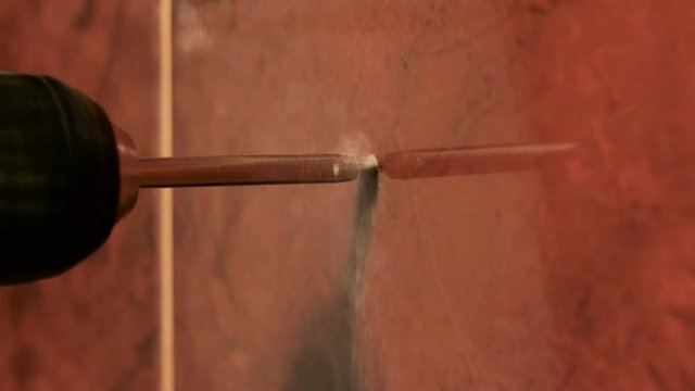 Drill ceramics rotates and drills a hole in ceramic tile