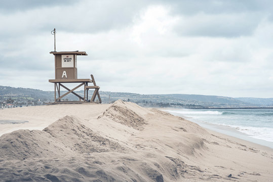 Stunning isolated beach scene, featuring a lifeguard tower and sand dunes.
