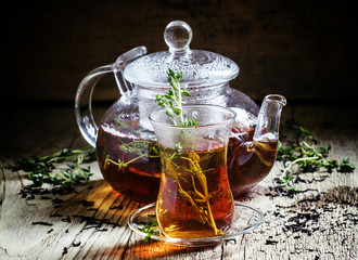 Middle East Black tea with thyme, ethnic glass and glass teapot,