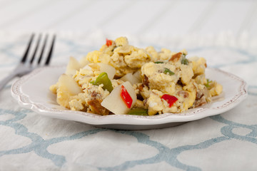 Scrambled eggs with Anaheim chilies, boiled potatoes, green peppers, and onions side view