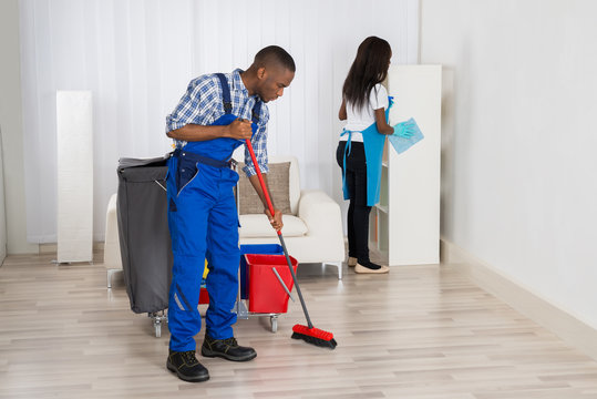 Two Cleaners Cleaning Apartment