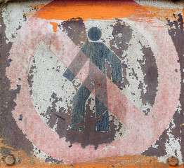Faded and shabby sign of danger on a metal plate