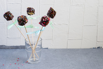 Banana Pops on a stick with chocolate and colorful sugar sprinkl