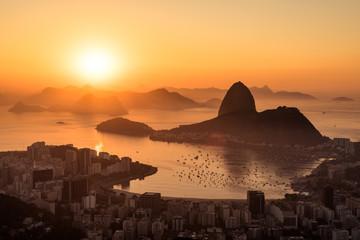 Fototapeta na wymiar Golden Sunrise over Guanabara Bay in Rio de Janeiro with Sugarloaf Mountain in the Horizon