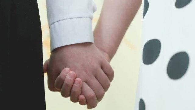Little boy and girl taking hands in kindergarten