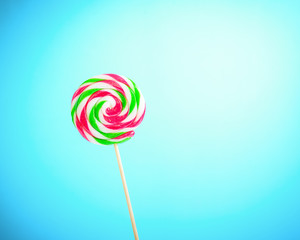 Lollipop on blue background with copy space.