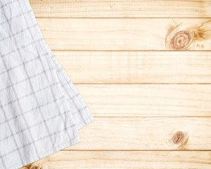 White tablecloth on wooden table with copy space.
