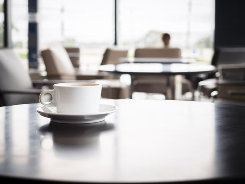 Coffee cup on table with blurred people in Restaurant shop cafe