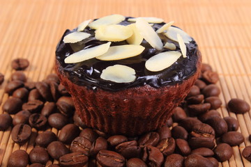 Chocolate muffins with sliced almonds and coffee grains