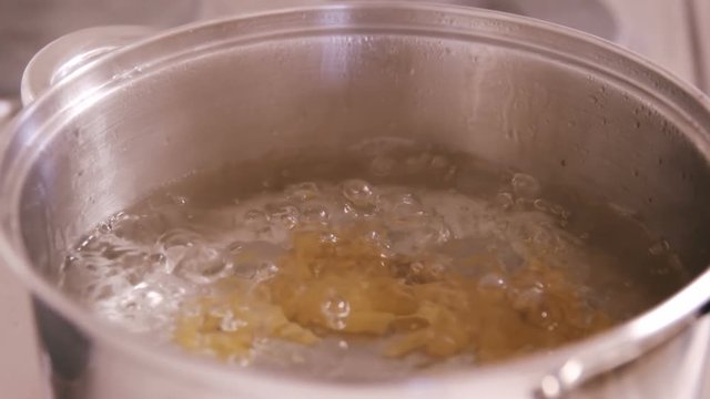 Close up on pasta boiling on the water