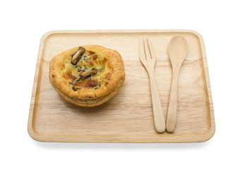 Mushroom-spinach quiche on wooden plate