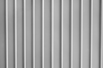 Seamless abstract background grey silver aluminium metal plate texture with vertical lines pattern.