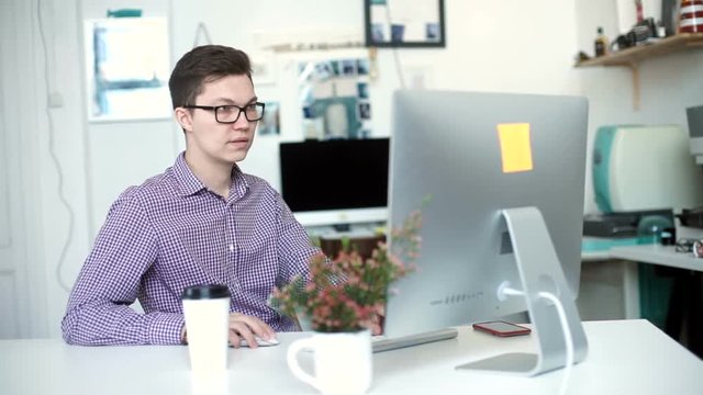 oung man working from home using smart phone and notebook computer