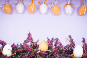 Decorated background for Easter with eggs and heather as a frame