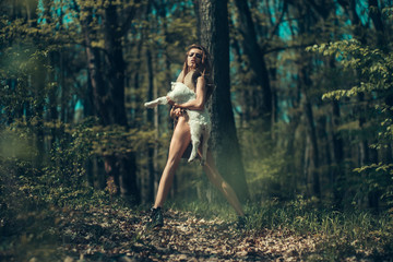 Young girl with goat in forest