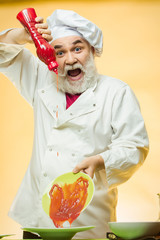 Bearded cook with ketchup bottle