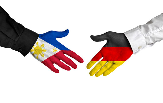 Philippines and Germany leaders shaking hands on a deal agreement