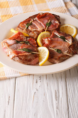 Beef Saltimbocca with sage and ham close-up. Vertical
