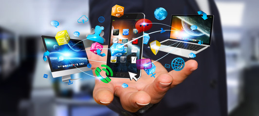Businessman holding tech devices and icons applications © sdecoret