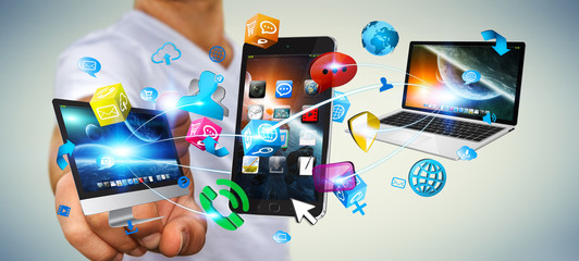 Businessman holding tech devices and icons applications © sdecoret