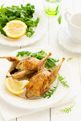 Delicious fried quail with herbs and greens.