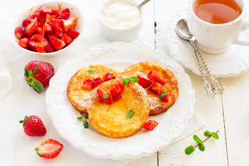 cottage cheese pancakes (cheese cakes) with strawberries and cream.