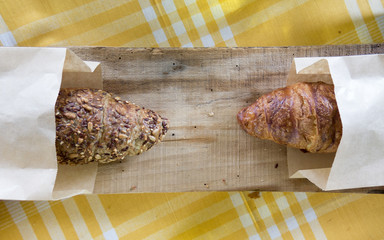 Full grain vs regular croissant croissant on the wooden plank