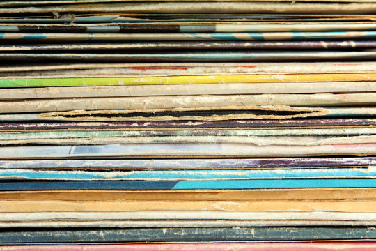 A Bunch Of Multicolored Packaging Of Vinyl Records Close-up View Of The Texture