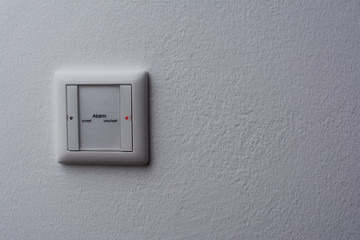 Alarmschalter unterputz in schalterdose auf unscharf mit roter statusled