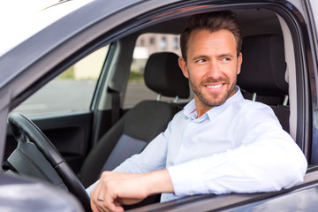 Young attractive man driving his car