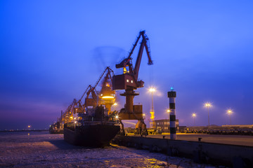 Fototapeta na wymiar Cargo wharf crane at night