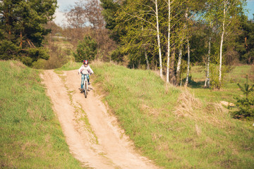 Fototapeta premium smiling little girl riding a bike 